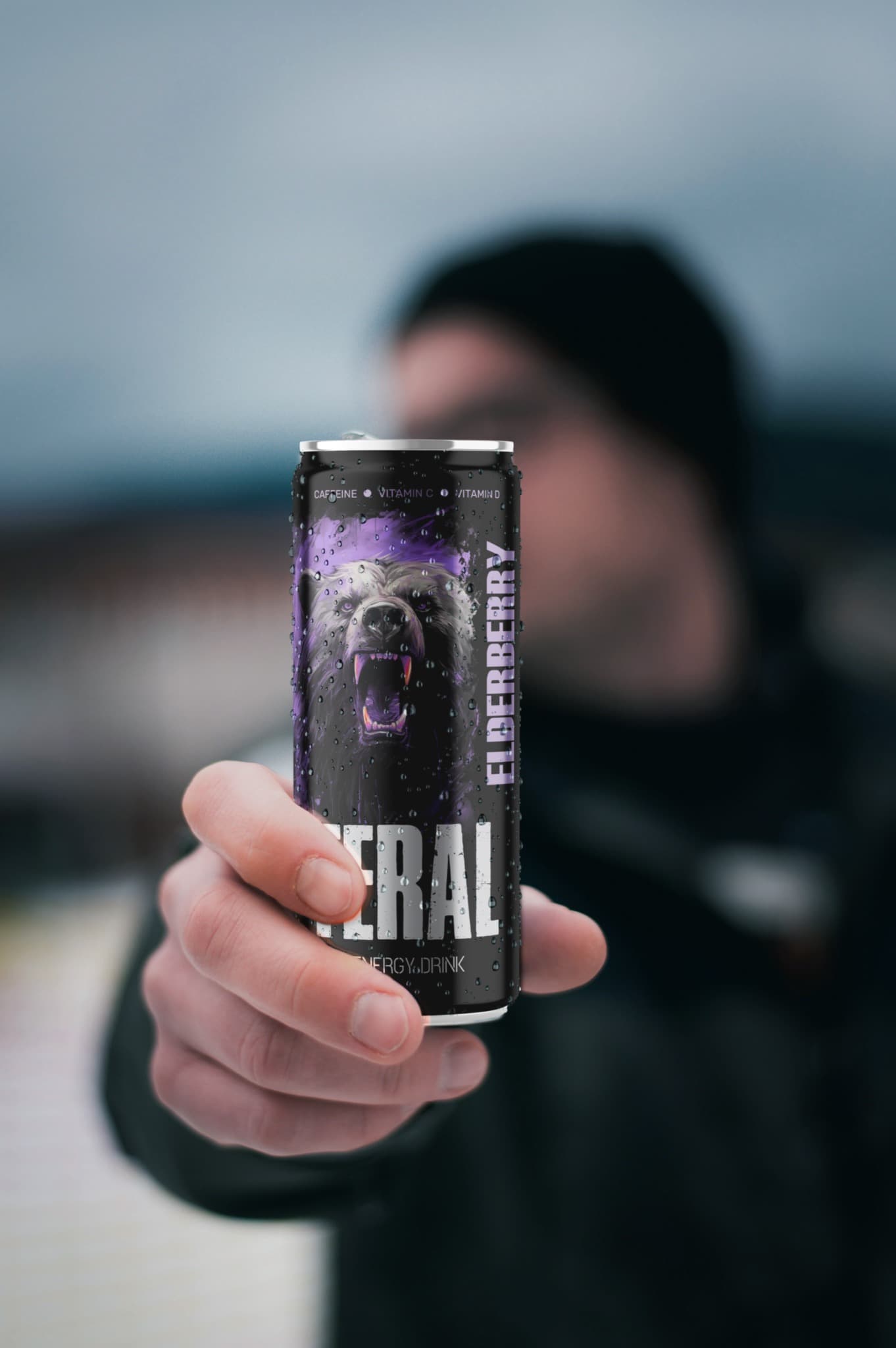 A person holding a FERAL Elderberry energy drink can.